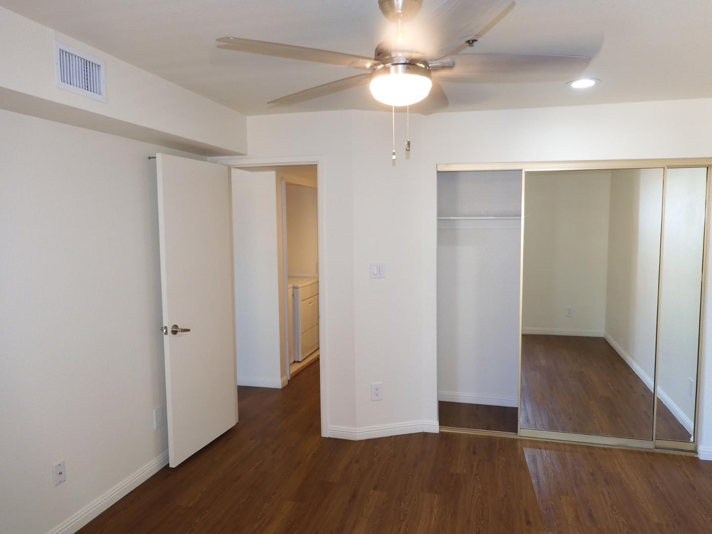 154 West 5th Street, Unit 233 Tempe, AZ 85281 - Photo 11 of 29 an empty room with wooden floor and ceiling fan