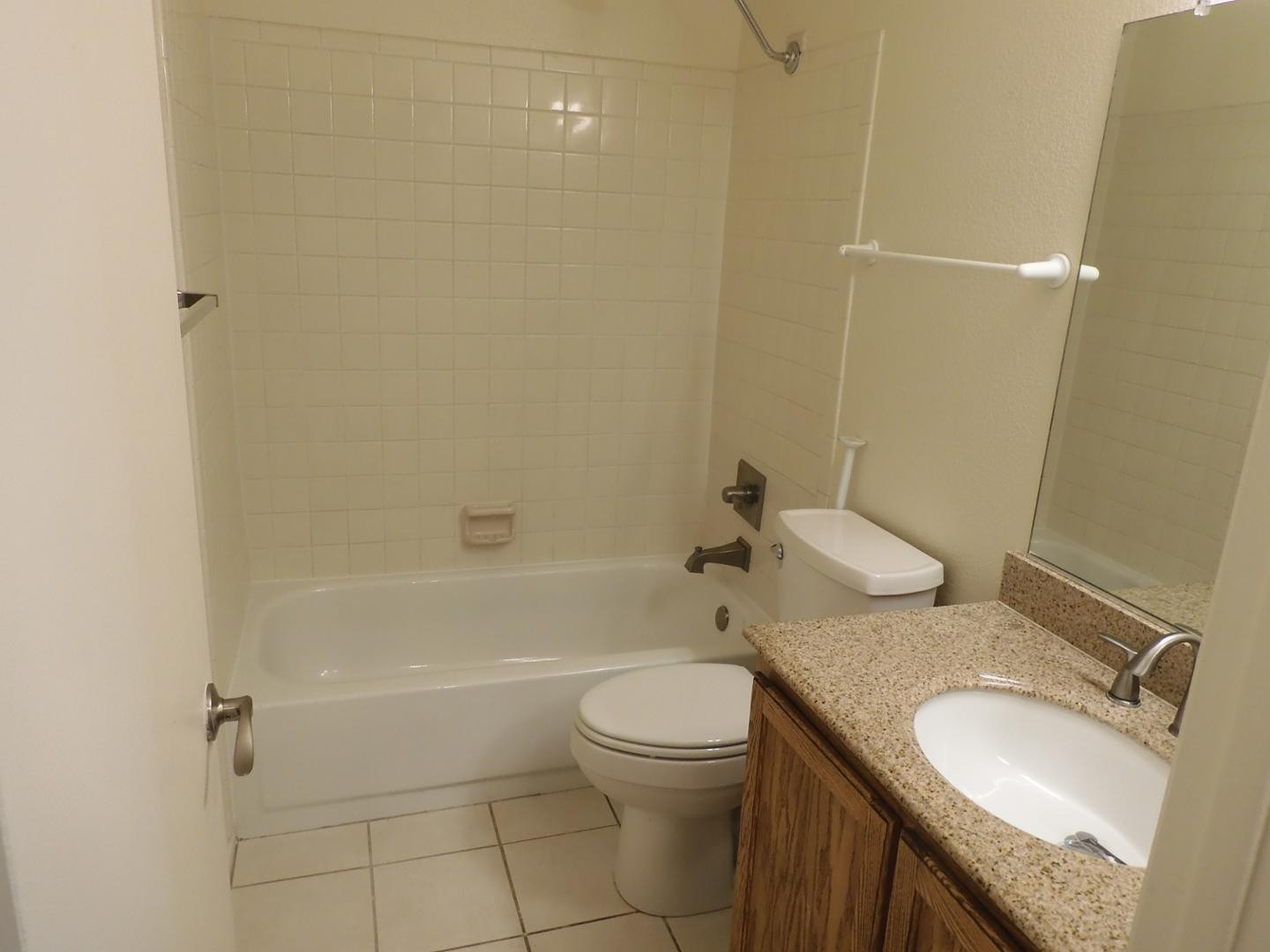 154 West 5th Street, Unit 233 Tempe, AZ 85281 - Photo 14 of 29 a bathroom with a granite countertop sink toilet and shower