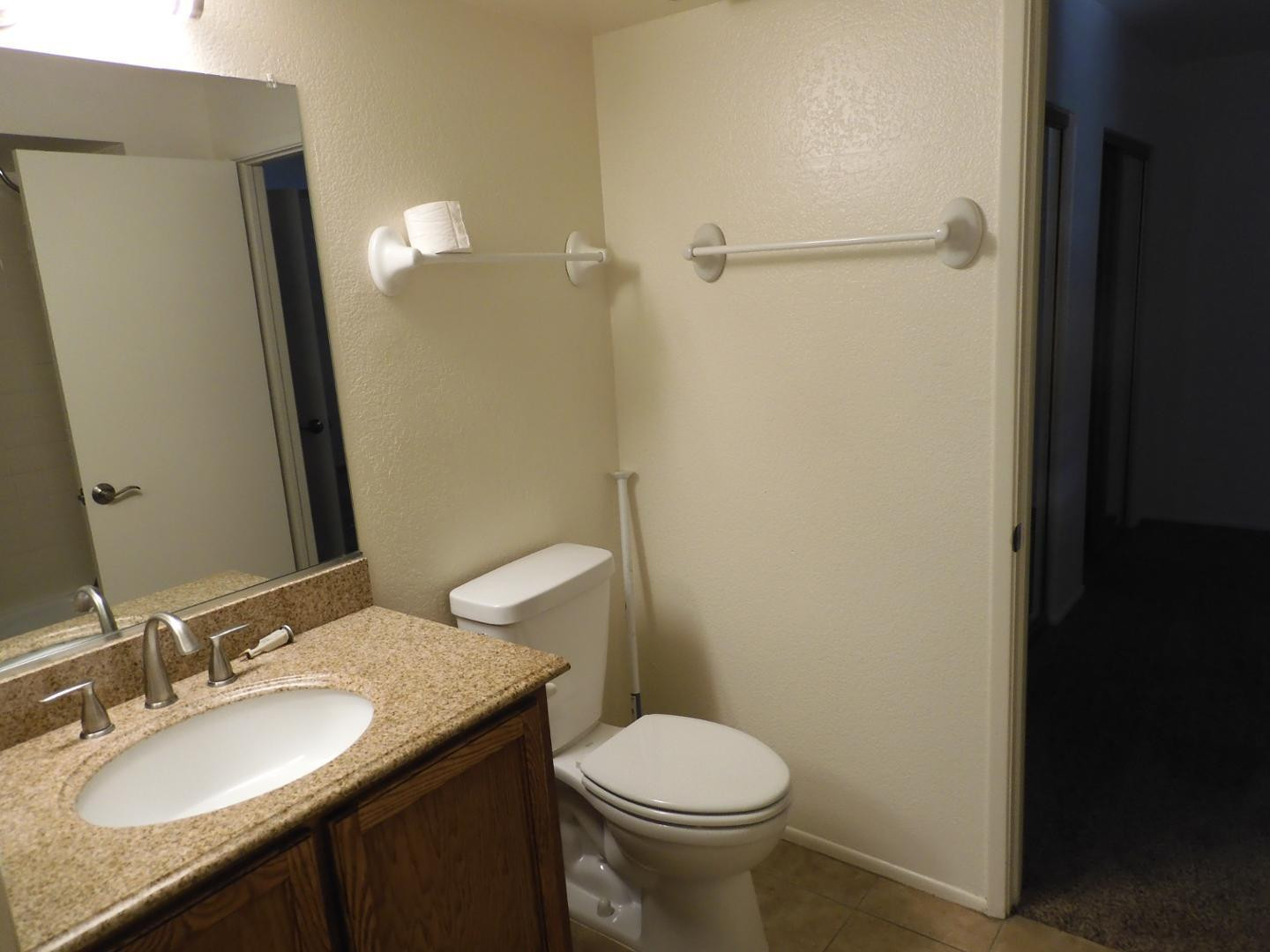 154 West 5th Street, Unit 233 Tempe, AZ 85281 - Photo 17 of 29 a bathroom with a granite countertop sink toilet and shower