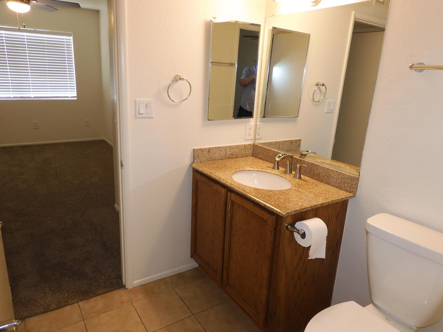154 West 5th Street, Unit 233 Tempe, AZ 85281 - Photo 18 of 29 a bathroom with a granite countertop sink and a mirror