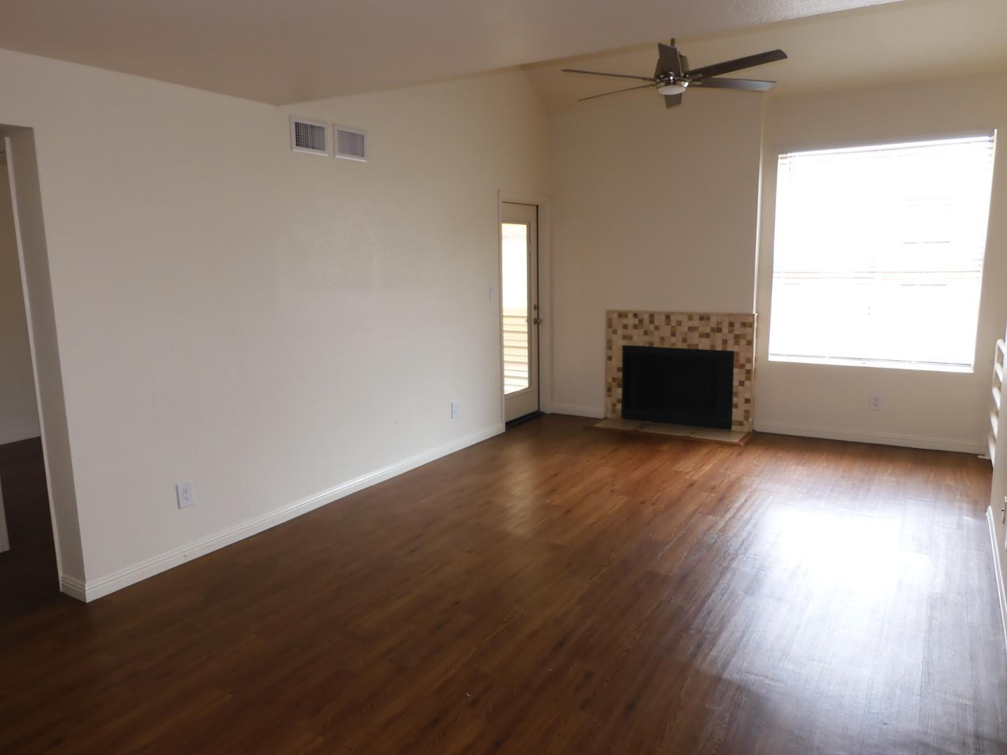 154 West 5th Street, Unit 233 Tempe, AZ 85281 - Photo 2 of 29 an empty room with wooden floor fireplace and windows