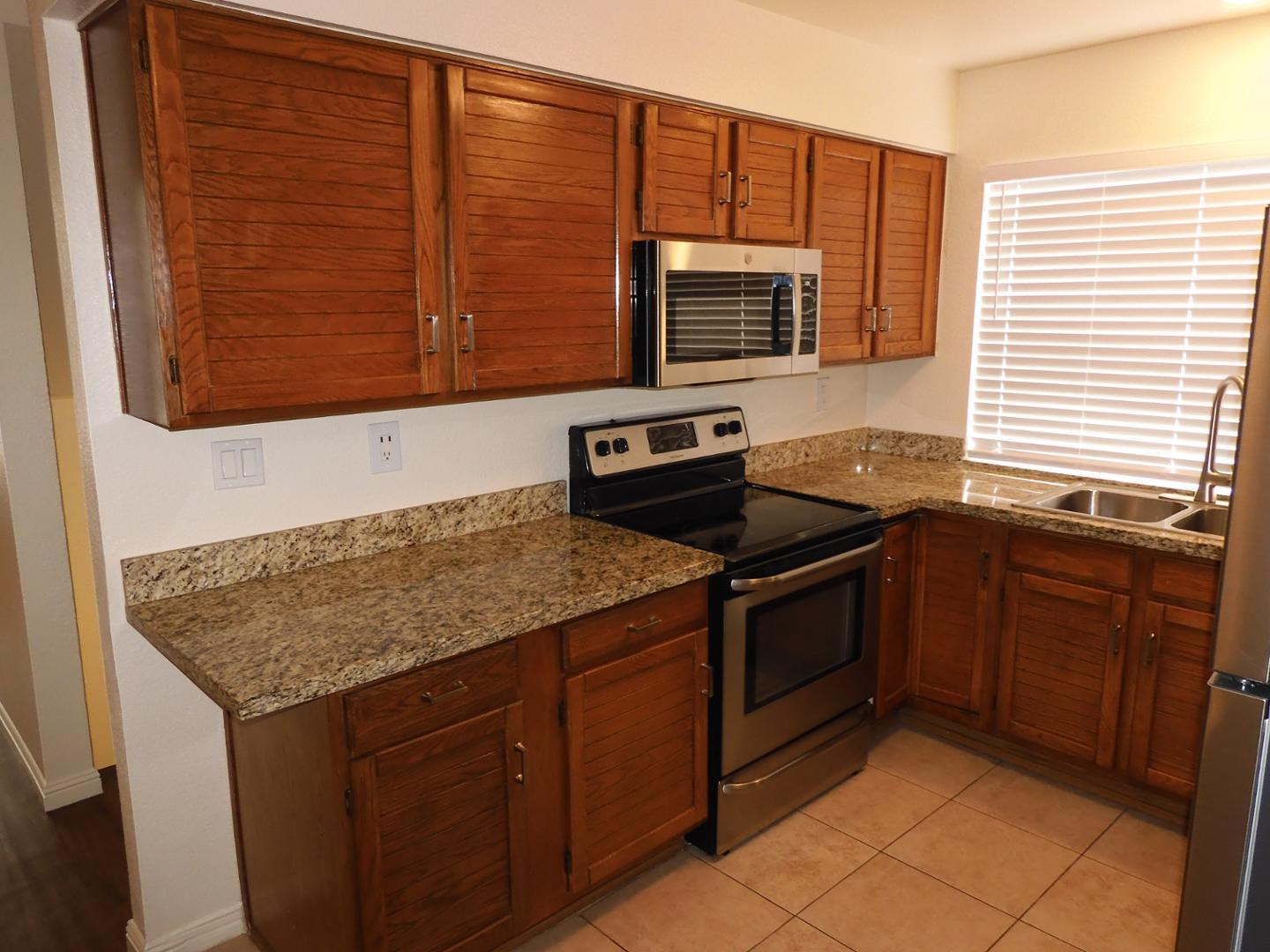 154 West 5th Street, Unit 233 Tempe, AZ 85281 - Photo 8 of 29 a kitchen with stainless steel appliances granite countertop a sink stove and microwave