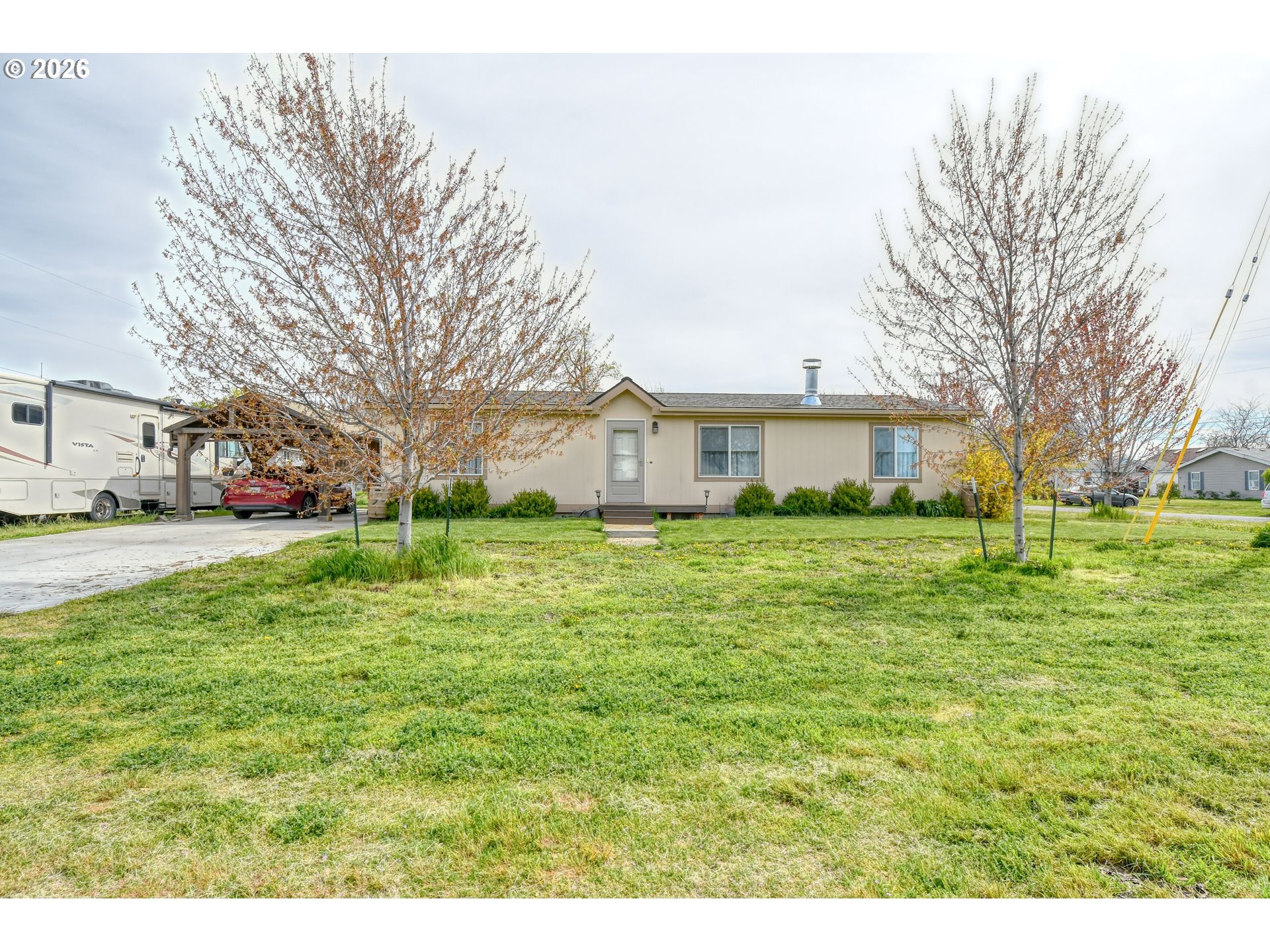 a front view of house with yard and green space