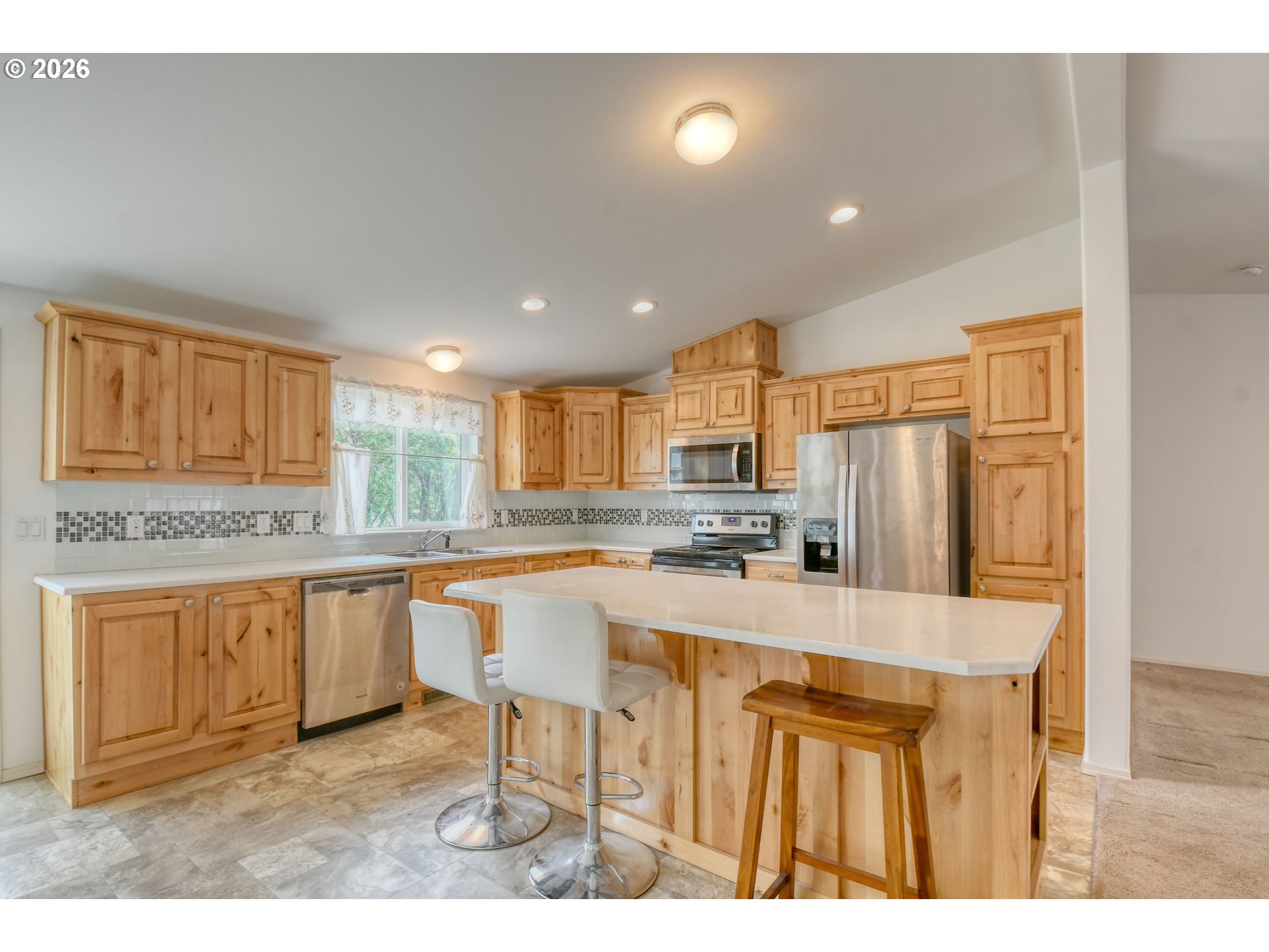303 East College Street Athena, OR 97813 - Photo 14 of 42 a large kitchen with kitchen island a sink table and chairs