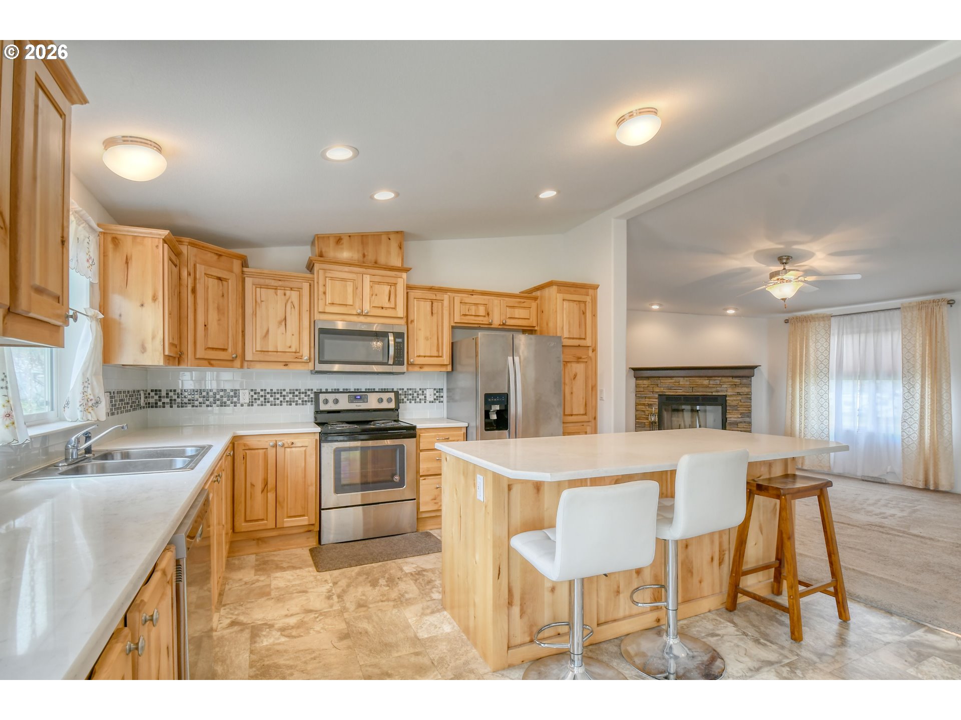 303 East College Street Athena, OR 97813 - Photo 15 of 42 a kitchen with a stove a sink a dining table and chairs
