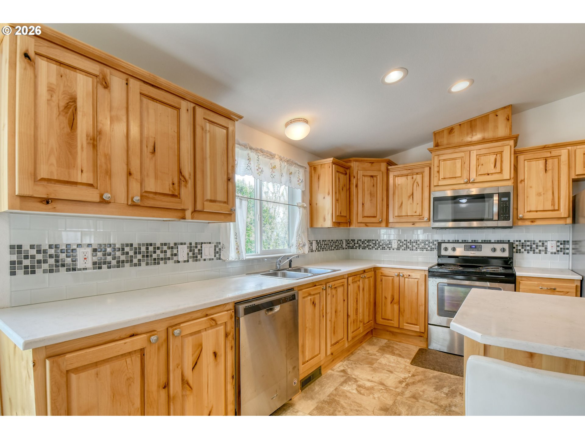 303 East College Street Athena, OR 97813 - Photo 16 of 42 a kitchen with stainless steel appliances granite countertop a sink a stove and cabinets