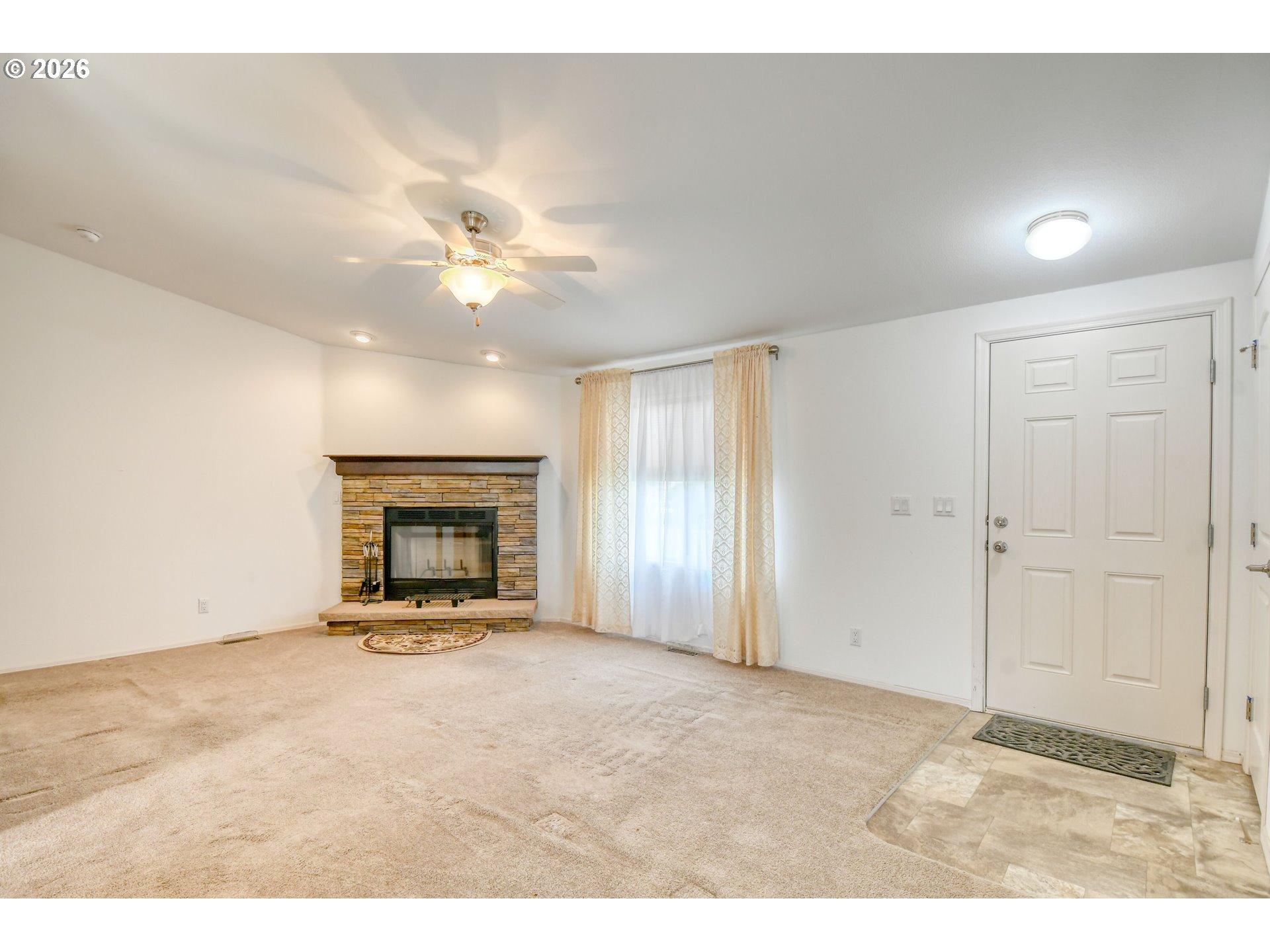 303 East College Street Athena, OR 97813 - Photo 5 of 42 a view of an empty room with a fireplace