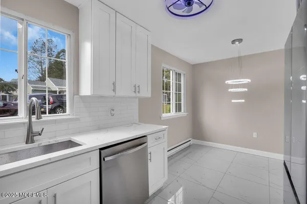 a kitchen with a sink cabinets and window