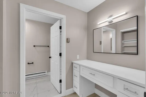 a bathroom with a shower and a mirror