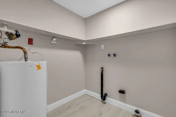 a view of a storage & utility room with two washing machine