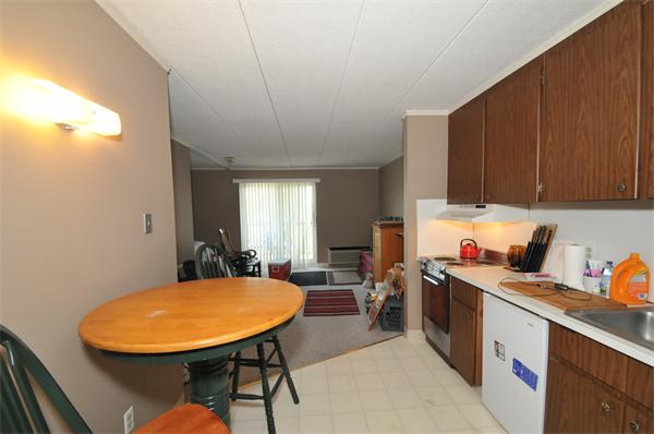 40 Cochituate Road, Unit 39 Framingham, MA 01701 - Photo 8 of 16 a view of a kitchen with kitchen island a sink a stove and a refrigerator