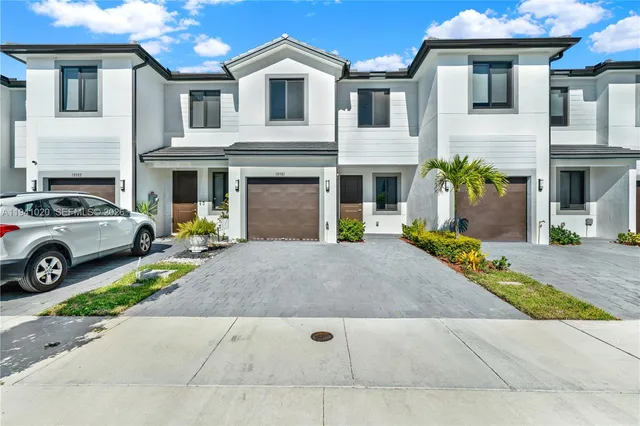 a view of a white house with a outdoor space