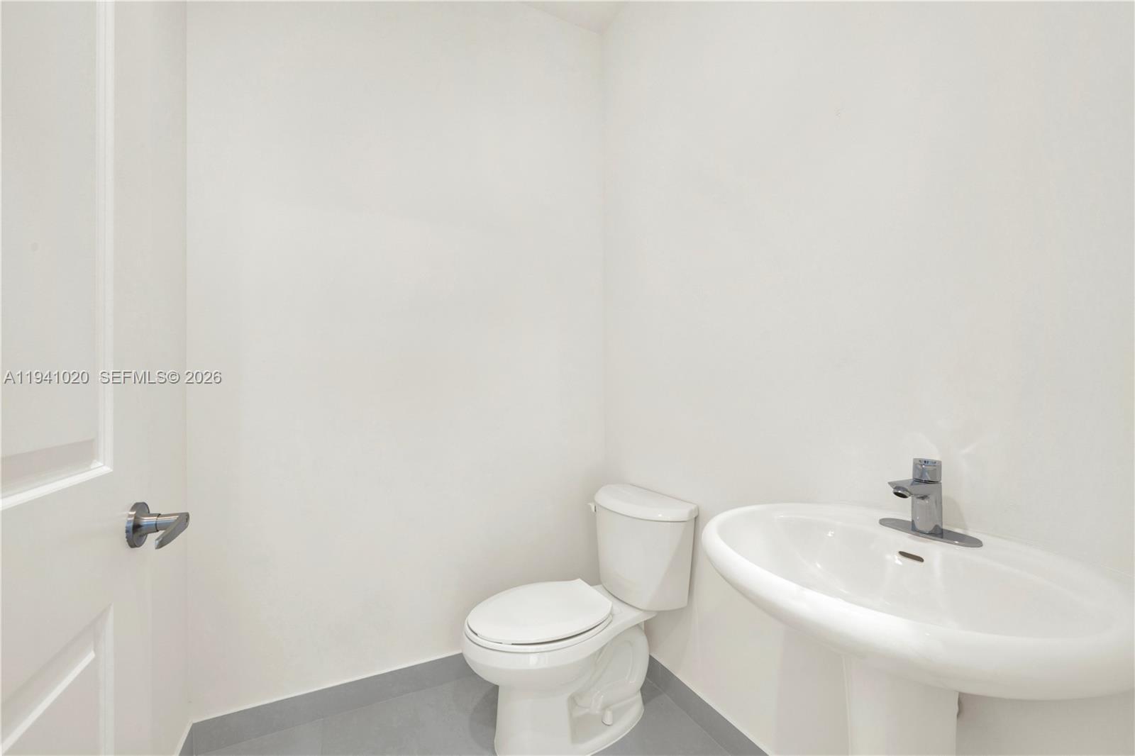 18981 Southwest 344th Terrace, Unit 18981 Homestead, FL 33034 - Photo 15 of 34 a bathroom with a sink a toilet and shower