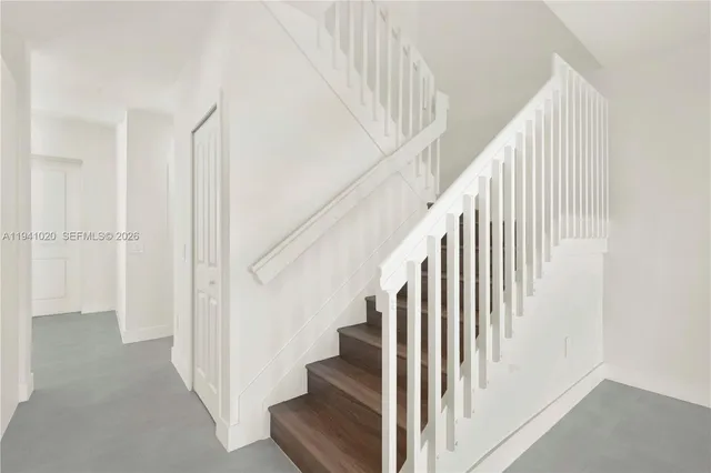 a view of hallway with wooden floor