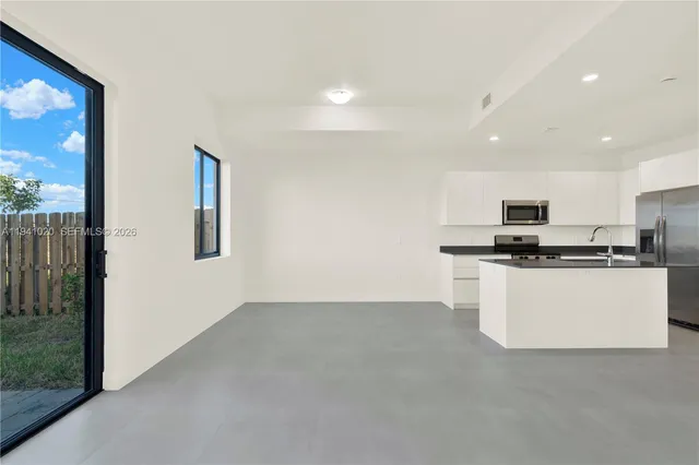 a view of an empty room with glass door