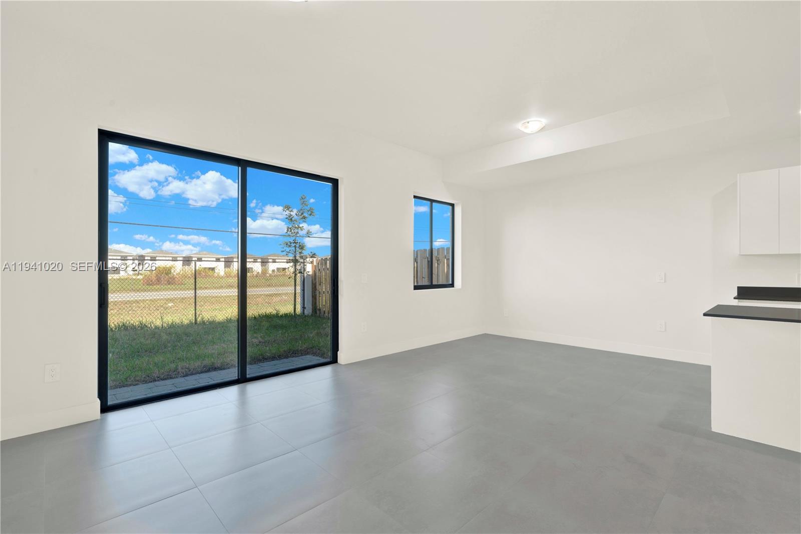 18981 Southwest 344th Terrace, Unit 18981 Homestead, FL 33034 - Photo 9 of 34 a view of an empty room with glass door