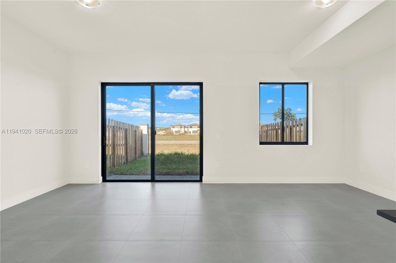 18981 Southwest 344th Terrace, Unit 18981 Homestead, FL 33034 - Photo 10 of 34 an empty room with sliding door