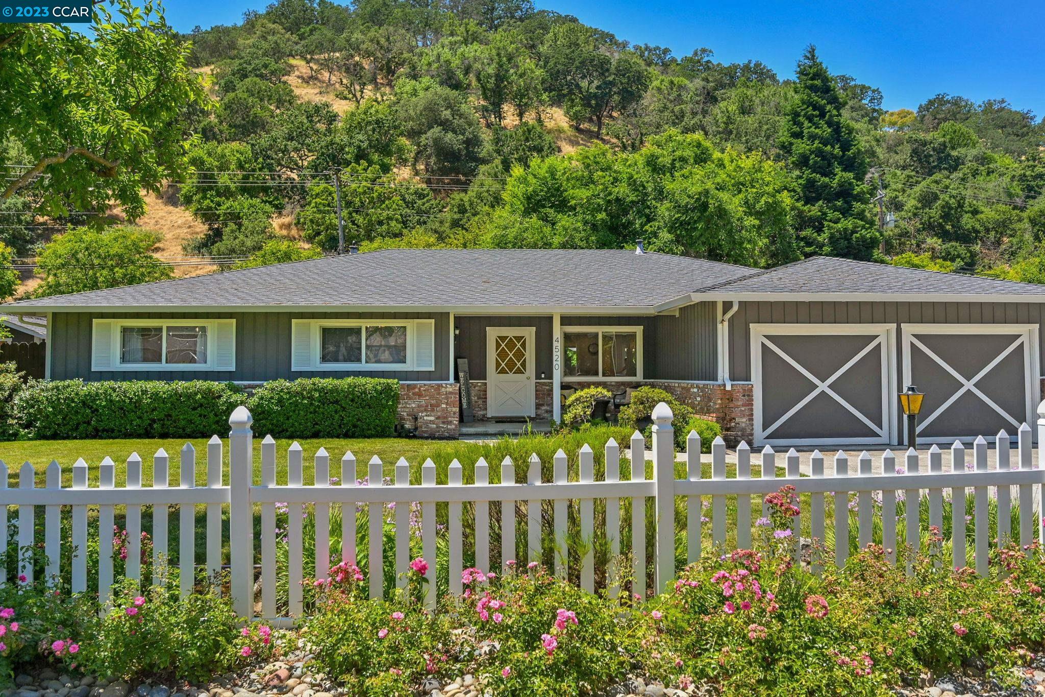 a front view of a house with garden