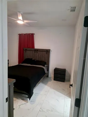 a bedroom with a bed and a window