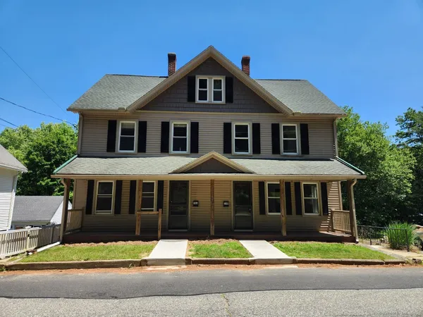 a front view of a house with a yard