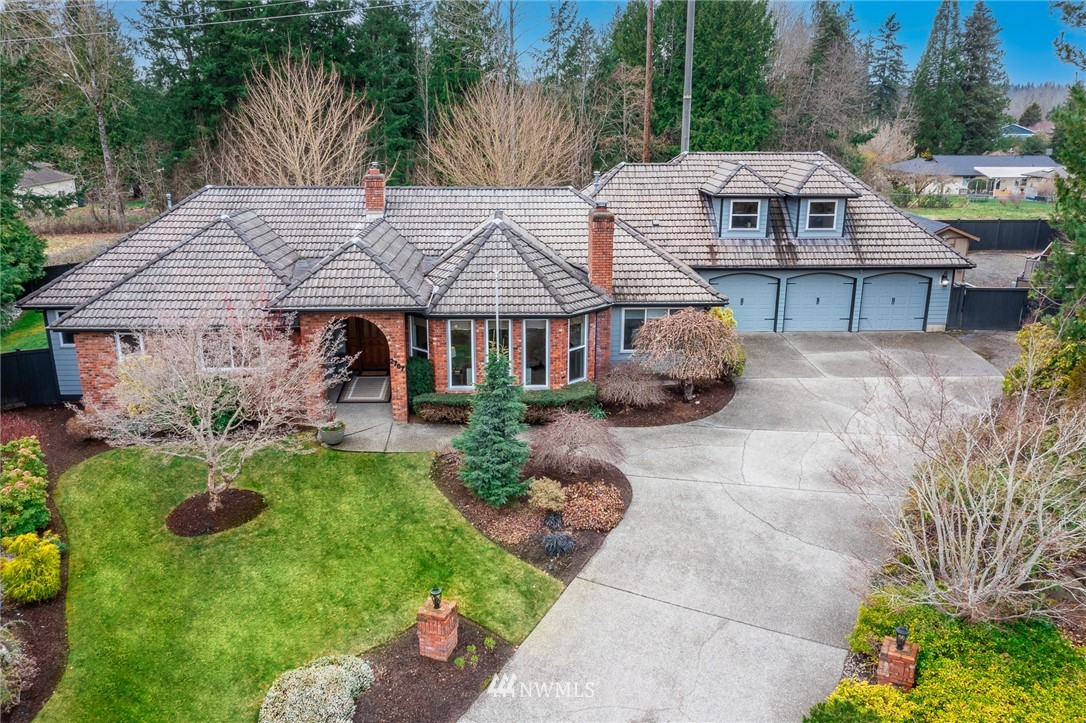 2707 187th Street Southeast Bothell, WA 98012 - Photo 1 of 39 a front view of a house with garden