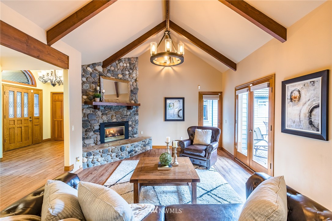 2707 187th Street Southeast Bothell, WA 98012 - Photo 4 of 39 a living room with furniture a fireplace and a large window