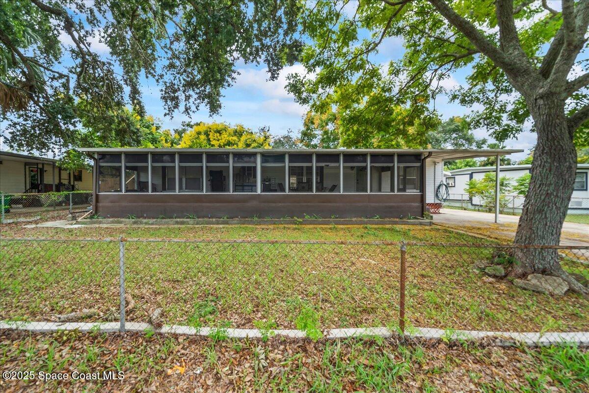 6983 Chestnut Drive Cocoa, FL 32927 - Photo 1 of 28 a view of a house with backyard and sitting area