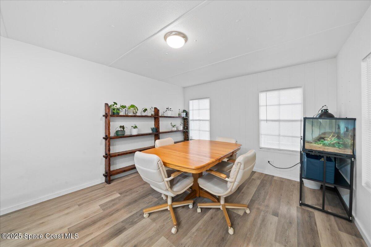 6983 Chestnut Drive Cocoa, FL 32927 - Photo 12 of 28 a view of a dining room with furniture and wooden floor