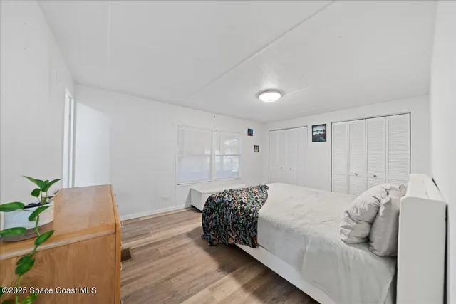 a bedroom with a bed and a potted plant