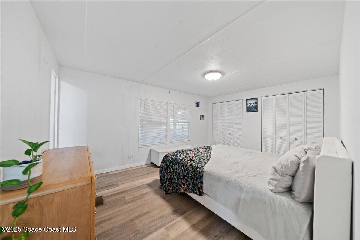 6983 Chestnut Drive Cocoa, FL 32927 - Photo 13 of 28 a bedroom with a bed and a potted plant