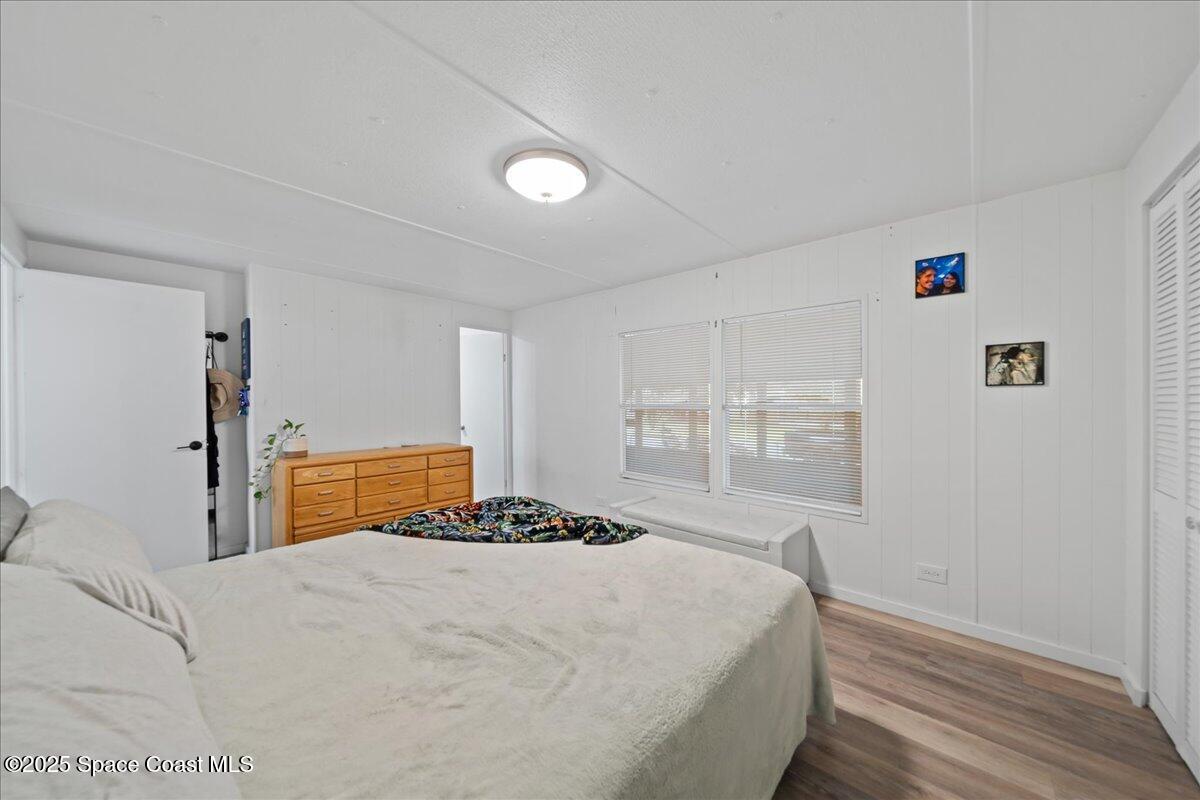 6983 Chestnut Drive Cocoa, FL 32927 - Photo 14 of 28 a bedroom with a bed and a window