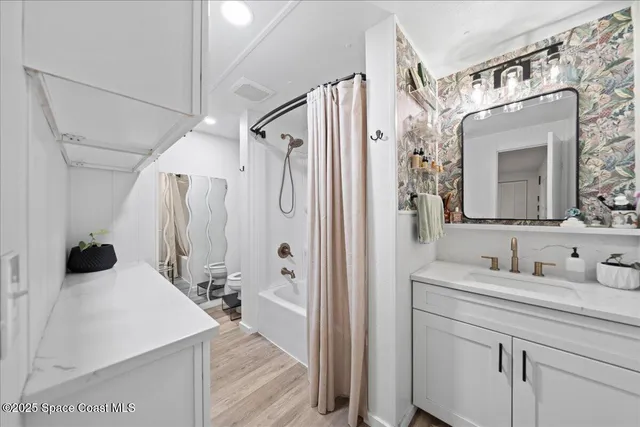 a en suite bathroom with a sink double vanity granite and a mirror