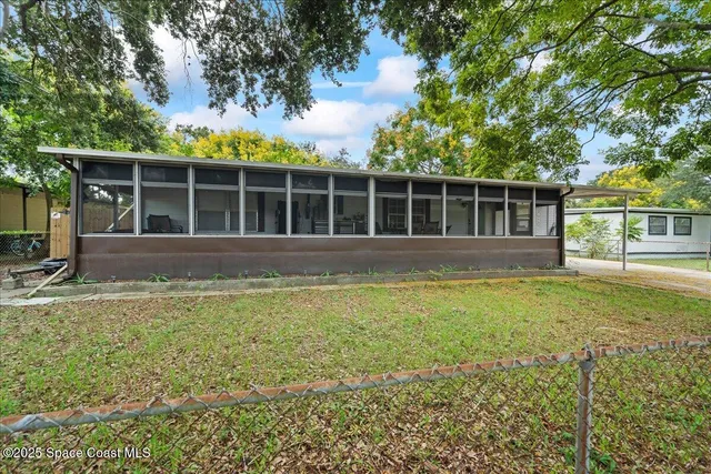 a view of house with backyard space and balcony