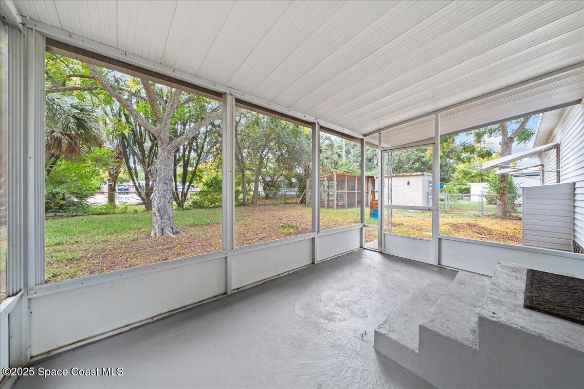 6983 Chestnut Drive Cocoa, FL 32927 - Photo 21 of 28 a view of an empty room with wooden floor and a floor to ceiling window