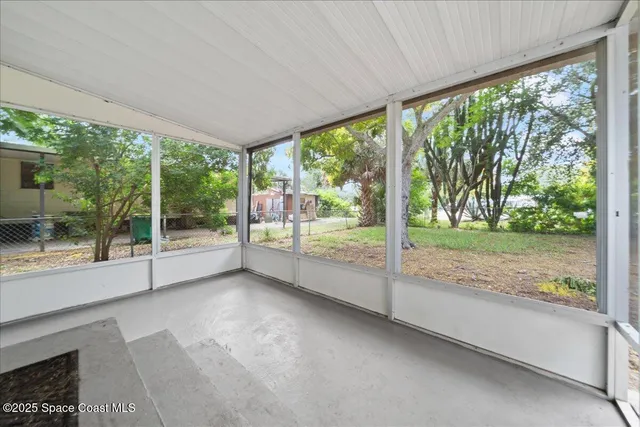 a view of a room with porch and wooden floor