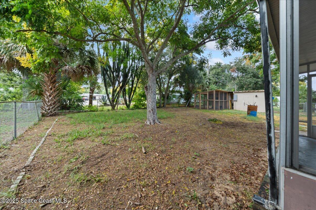 6983 Chestnut Drive Cocoa, FL 32927 - Photo 24 of 28 a view of a yard with tree s