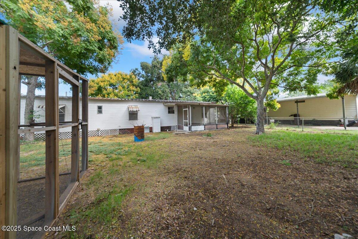 6983 Chestnut Drive Cocoa, FL 32927 - Photo 26 of 28 a backyard of a house with seating space