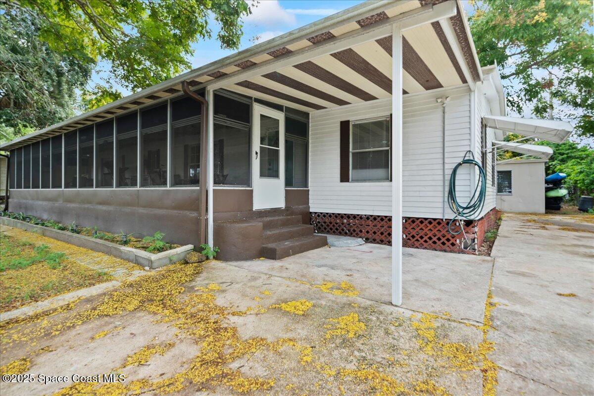 6983 Chestnut Drive Cocoa, FL 32927 - Photo 3 of 28 a front view of a house with garden