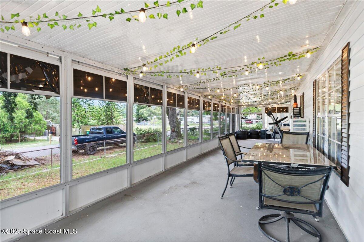 6983 Chestnut Drive Cocoa, FL 32927 - Photo 4 of 28 a dining room with furniture and a floor to ceiling window