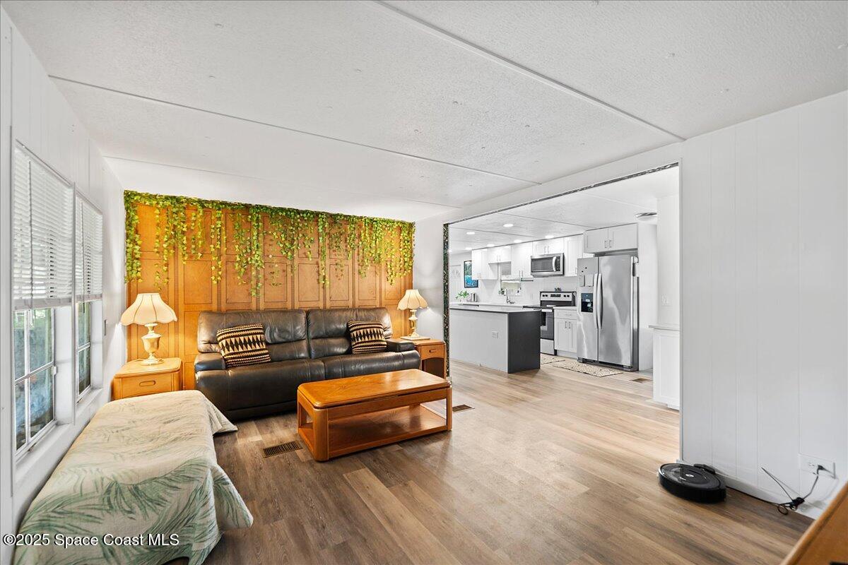 6983 Chestnut Drive Cocoa, FL 32927 - Photo 6 of 28 a living room with furniture and a wooden floor