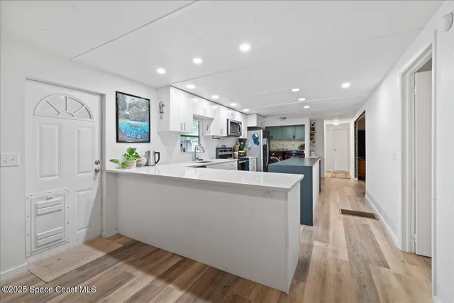 a view of kitchen with cabinets and outdoor space