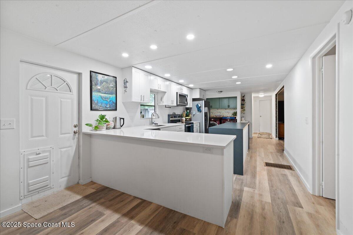 6983 Chestnut Drive Cocoa, FL 32927 - Photo 10 of 28 a view of kitchen with cabinets and outdoor space