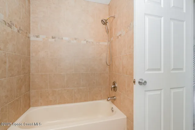 a bath tub sitting next to a white sink