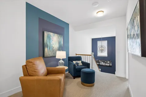 a living room with furniture and a potted plant