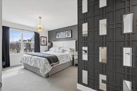 a bedroom with a bed and glass door