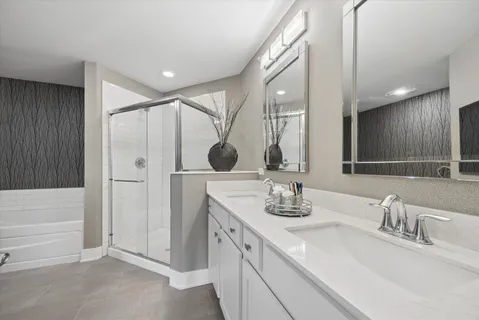 a bathroom with a double vanity sink and mirror
