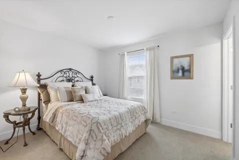 a bedroom with a bed and lamp