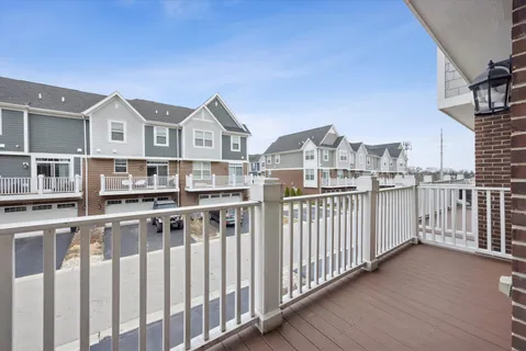 a view of a balcony with a table and chairs