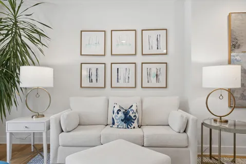 a living room with furniture a table and a potted plant