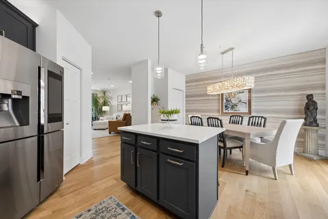 a kitchen with a table chairs refrigerator and microwave